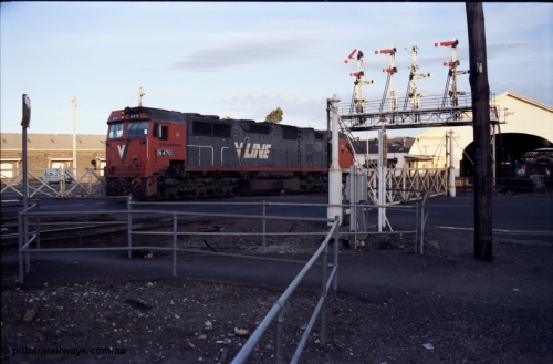 140-2-14
Ballarat station, V/Line broad gauge N class N 470 'City of Wangaratta' Clyde Engineering EMD model JT22HC-2 serial 86-1199 crosses Lydiard Street as it runs round the carriage set, through the interlocked gates and under the signal gantry on No.4 Rd, semaphore signal post 29 is pulled off for the move, this signal is controlled from A Box, while the signal is across the road from B Box.
Keywords: N-class;N470;Clyde-Engineering-Somerton-Victoria;EMD;JT22HC-2;86-1199;