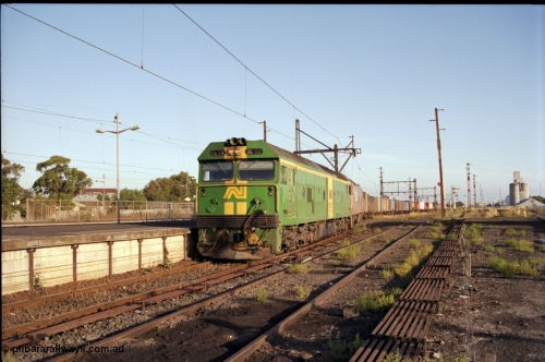 141-1-06
Sunshine, broad gauge down Adelaide goods train behind Australian National BL class BL 33 Clyde Engineering EMD model JT26C-2SS serial 83-1017 and V/Line G class G 515 Clyde Engineering EMD model JT26C-2SS serial 85-1243 pass platform No.3 as its consist crosses over the passenger lines from the Independent Through Lines heading the main western line, station platform, semaphore and disc signal posts, points, point rodding, looking east, Newport Loop Line on the right, GEB silo complex.
Keywords: BL-class;BL33;Clyde-Engineering-Rosewater-SA;EMD;JT26C-2SS;83-1017;