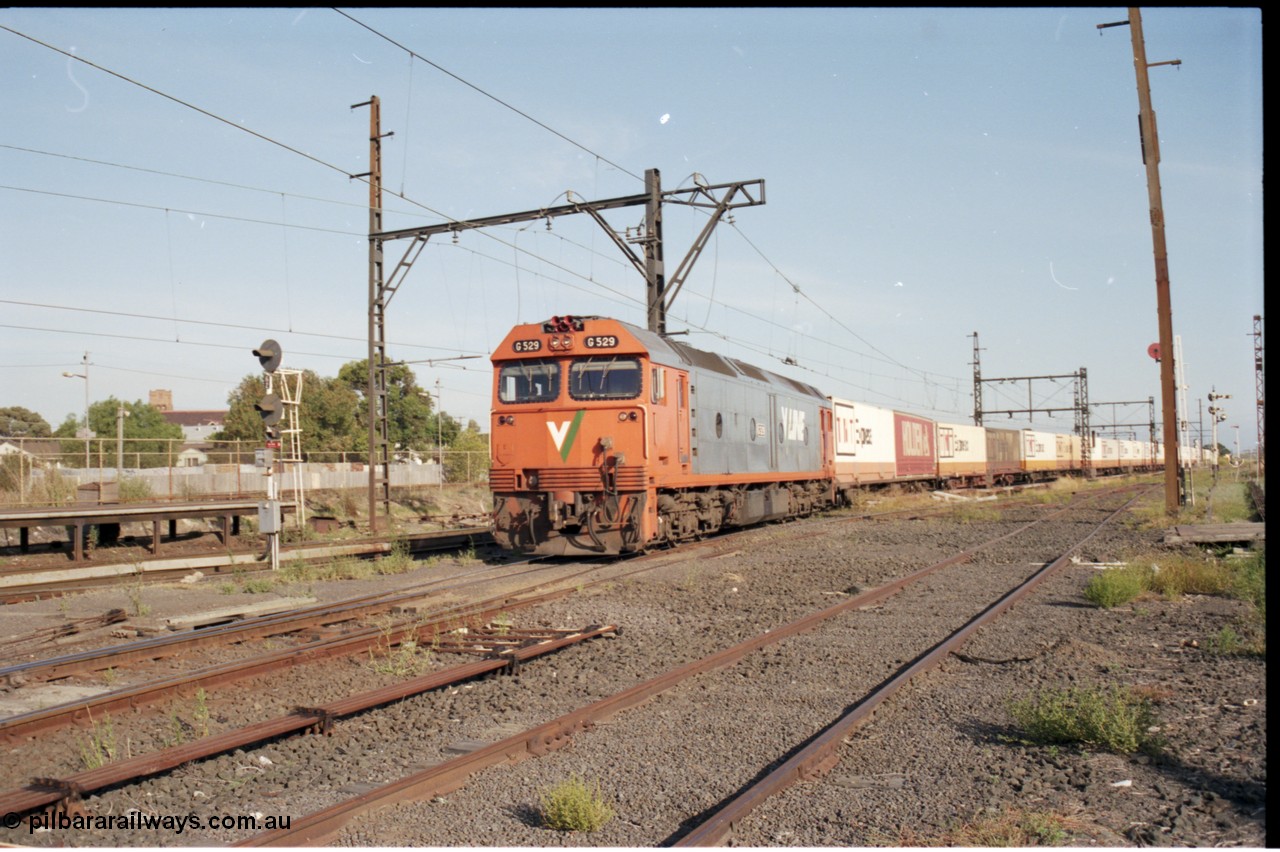 141-2-15
Sunshine, broad gauge V/Line G class G 529 Clyde Engineering EMD model JT26C-2SS serial 88-1259 solo leads an Adelaide bound down Super Freighter service with mainly TNT loading as it runs round the back of Sunshine through platform 3, looking east from former goods yard, point rodding.
Keywords: G-class;G529;Clyde-Engineering-Somerton-Victoria;EMD;JT26C-2SS;88-1259;