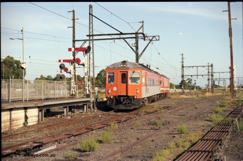 141-2-13
Sunshine, broad gauge V/Line Tulloch Ltd DRC class diesel rail car and MTH class trailer carriage arrive at platform No.3 past semaphore and disc signal post 33 with a Bacchus Marsh bound down passenger service, looking east, point rodding, former goods yard.
Keywords: DRC-class;Tulloch-Ltd-NSW;