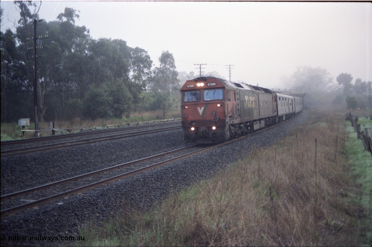 142-1-06
Seymour, V/Line standard gauge G class G 526 Clyde Engineering EMD model JT26C-2SS serial 88-1256 leads the south bound Melbourne Express on a very foggy morning.
Keywords: G-class;G526;Clyde-Engineering-Somerton-Victoria;EMD;JT26C-2SS;88-1256;