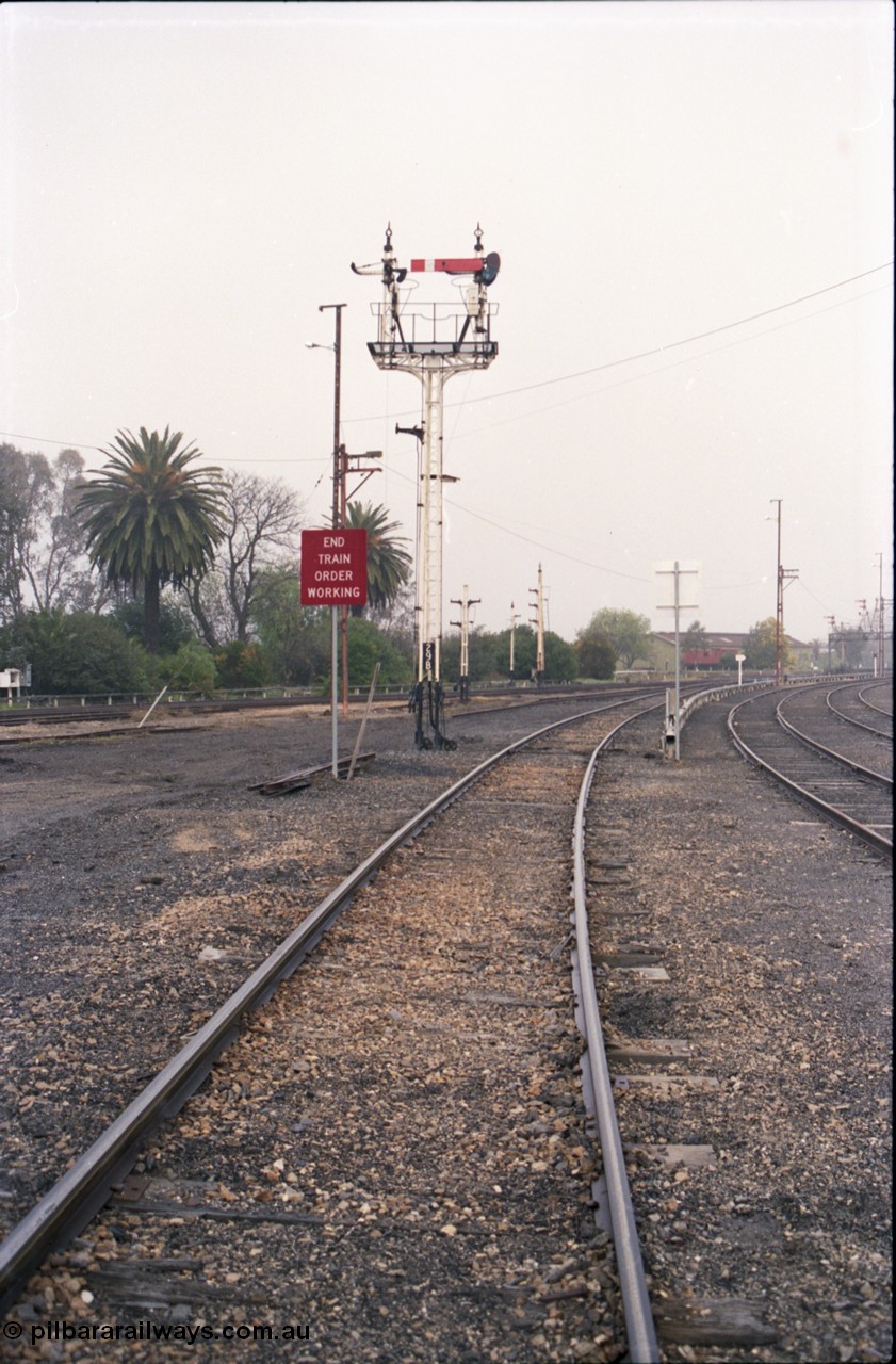 142-1-20
Benalla station yard view from Yarrawonga line, signal post 29B mostly stripped, disc signal posts 29 and 32 stripped in the background, workshops building visible is the distance, Sidings J and K visible at right.
