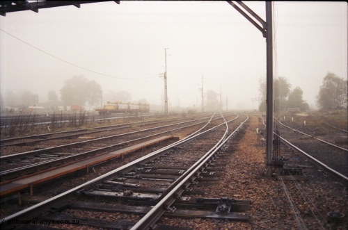 142-1-16
Benalla yard overview looking north, Yarrawonga line points spike for normal, looking from signal post 27, loco depot track at right, yard being rationalised.
