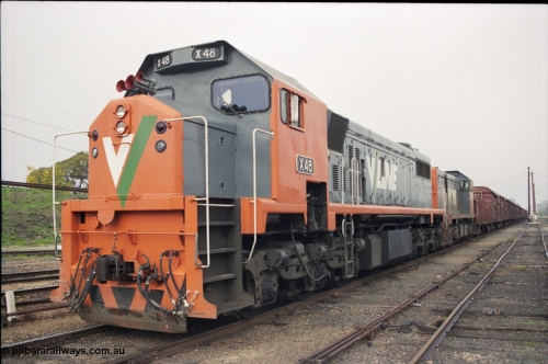 142-1-26
Benalla yard view, stabled broad gauge Wodonga goods train 9303 with V/Line X class X 48 Clyde Engineering EMD model G26C serial 75-795 and T class T 408 Clyde Engineering EMD model G18B serial 68-624.
Keywords: X-class;X48;Clyde-Engineering-Rosewater-SA;EMD;G26C;75-795;