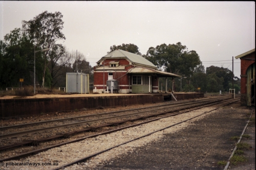 142-2-09
Barnawartha station building and yard overview looking south, point rodding down middle of yard, goods shed at extreme right, standard gauge runs behind station building.

