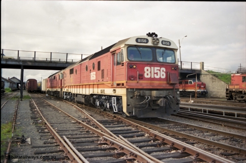 142-3-00
Albury station yard, standard gauge NSWSRA candy liveried 81 class locos 8156 Clyde Engineering EMD model JT26C-2SS serial 84-1075 and 8180 serial 85-1099 bring a south bound down goods train into the platform where they will cut off and head to loco and V/Line power will attach and continue to Melbourne on the now up goods.
Keywords: 81-class;8180;Clyde-Engineering-Kelso-NSW;EMD;JT26C-2SS;85-1099;