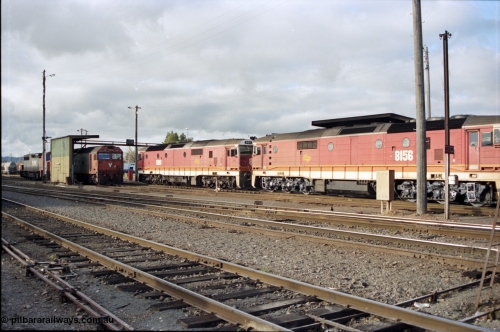 142-3-04
Albury loco depot fuel point overview, standard gauge V/Line G and C class locos at left with twin NSWSRA standard gauge candy liveried 81 class units 8180 Clyde Engineering EMD model JT26C-2SS serial 85-1099 and 8156 serial 84-1075 shunt past light engine.
Keywords: 81-class;8156;Clyde-Engineering-Kelso-NSW;EMD;JT26C-2SS;84-1075;