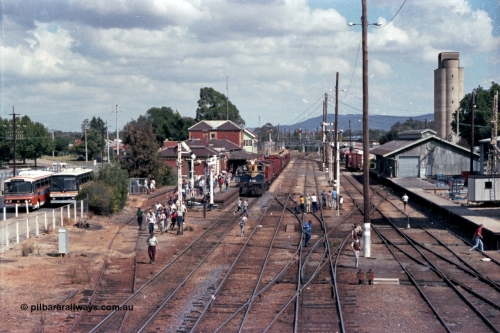 143-05
Wangaratta station yard overview looking south from footbridge, VR liveried Y class Y 133 Clyde Engineering EMD model G6B serial 65-399 with the board gauge down Wahgunyah Special 'Stringybark Express' at the platform pauses for the photo stop, controlling rail enthusiasts can be a lot like herding cats!!, the fully interlocked yard and 18th century infrastructure clearly on display here, semaphore signal Post 20 is pulled off for departure, station building and platform, elevated signal box, signal posts and interlocking, goods shed and water tower.
Keywords: Y-class;Y133;Clyde-Engineering-Granville-NSW;EMD;G6B;65-399;