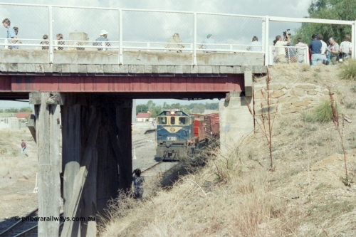 143-21
Rutherglen, view through the piers of the High St over bridge, broad gauge VR liveried Y class Y 133 Clyde Engineering EMD model G6B serial 65-399 departs as a plethora of enthusiasts capture the moment of the last down 'Stringybark Express' mixed train.
Keywords: Y-class;Y133;Clyde-Engineering-Granville-NSW;EMD;G6B;65-399;