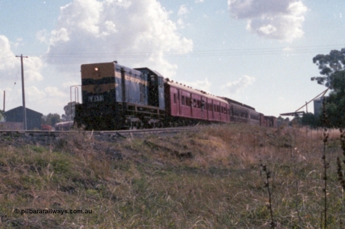 143-31
Wahgunyah, up 'Stringybark Express' mixed special powered by broad gauge VR liveried Y class Y 133 Clyde Engineering EMD model G6B serial 65-399 departs for Rutherglen, the super sheds and waggons visible to the left of the loco and the grain silos on the right, 2 BCPL class bogie passenger carriages lead the consist.
Keywords: Y-class;Y133;Clyde-Engineering-Granville-NSW;EMD;G6B;65-399;