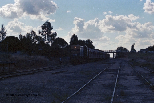 143-35
Rutherglen, up broad gauge Wahgunyah 'Stringybark Express' mixed special arrives on the mainline having just passed under the High St bridge hauled by VR liveried Y class Y 133 Clyde Engineering EMD model G6B serial 65-399 (underexposed).
