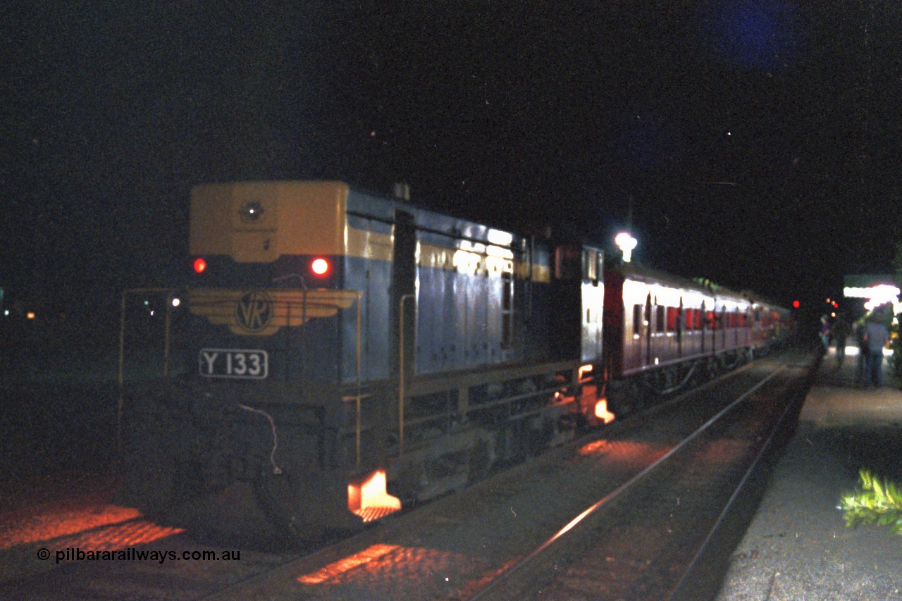 144-22
Euroa station platform view, broad gauge VR liveried Y class Y 133 Clyde Engineering EMD model G6B serial 65-399 with the up Wahgunyah 'Stringybark Express' mixed sits in No. 2 Rd awaiting a cross, night time exposure.
Keywords: Y-class;Y133;Clyde-Engineering-Granville-NSW;EMD;G6B;65-399;