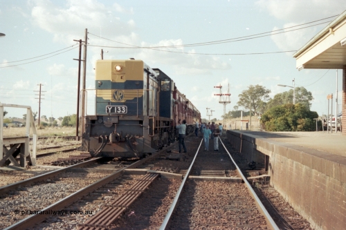 144-04
Springhurst station yard view, broad gauge up Wahgunyah 'Stringybark Express' mixed special hauled by VR liveried Y class Y 133 Clyde Engineering EMD model G6B serial 65-399 pauses on No. 2 Rd to change the Rutherglen - Springhurst train staff for the electric staff to Wangaratta, staff exchange platform at left, point rodding and station platform at right, semaphore signal Posts 6 and 2 visible in the distance.
Keywords: Y-class;Y133;Clyde-Engineering-Granville-NSW;EMD;G6B;65-399;