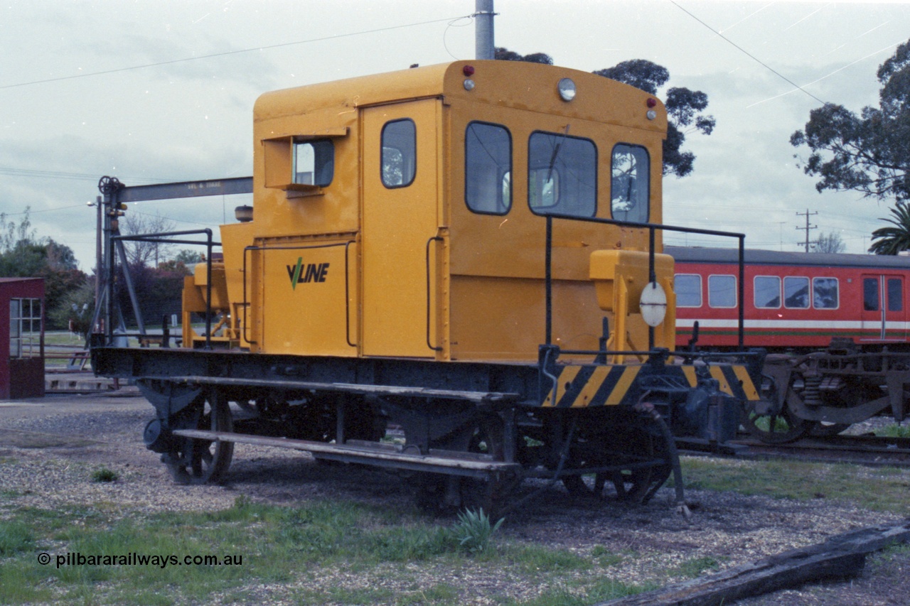 147-35
Seymour loco depot, yellow liveried V/Line rail tractor on the turn table roads, H car behind it.
