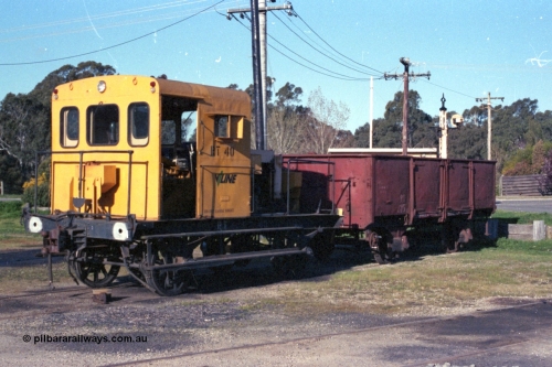 147-25
Seymour loco depot, broad gauge V/Line Rail Tractor RT 40 in yellow livery coupled to RY class open waggon RY 615. RT 40 was built in June 1967 at Ballarat North Workshops using the underframe of 1905 built I type I 7539 with was recoded to IA type in 1936. The RY started life in 1933 built as an IZ type, July 1966 recoded to RY.
Keywords: RT-class;RT40;RY-type;RY615;