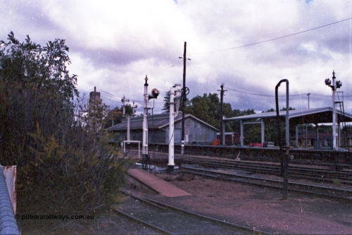 148-03
Wangaratta, view of disc signal post 18 for Siding A to Main Line, old and new water standpipes and twin disc signal post 19, goods shed and platform with 'Freight Gate' canopy in the background.
