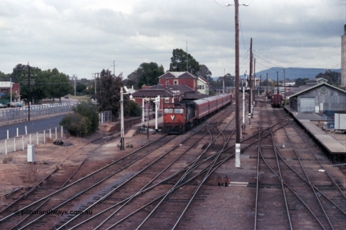 148-07
Wangaratta yard view with V/Line broad gauge N class N 460 'City of Castlemaine' Clyde Engineering EMD model JT22HC-2 serial 85-1228 on down Albury passenger at the station.
Keywords: N-class;N460;Clyde-Engineering-Somerton-Victoria;EMD;JT22HC-2;85-1228;