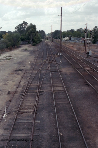 148-33
Wangaratta yard looking north (down direction) from footbridge at Nos. 5 and 4 Road extensions, point blades and K crossing for Siding J still in situ on No. 5 Road, double compound points on No. 4 Road to Siding 'C', then Main Line and Signal Post 23, standard gauge line in cutting at extreme right.

