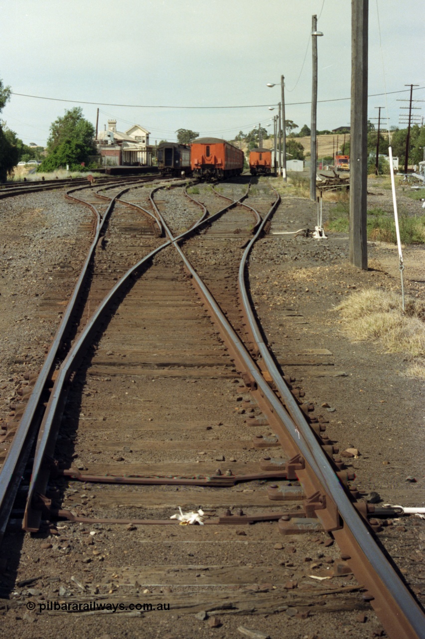 149-20
Bacchus Marsh station yard overview with stabled passenger sets looking Up direction at Nos. 3, 4, 5 and 6 Roads towards Melbourne, station and elevated signal box visible in the background.
