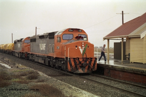 150-08
Gheringhap, V/Line broad gauge C class pair of C 506 Clyde Engineering EMD model GT26C serial 76-829 and C 510 serial 76-833 have paused to swap the electric staff for a train order, signaller has the staff and hoop, raining, train is 9169 Adelaide bound goods via Cressy.
Keywords: C-class;C506;Clyde-Engineering-Rosewater-SA;EMD;GT26C;76-829;