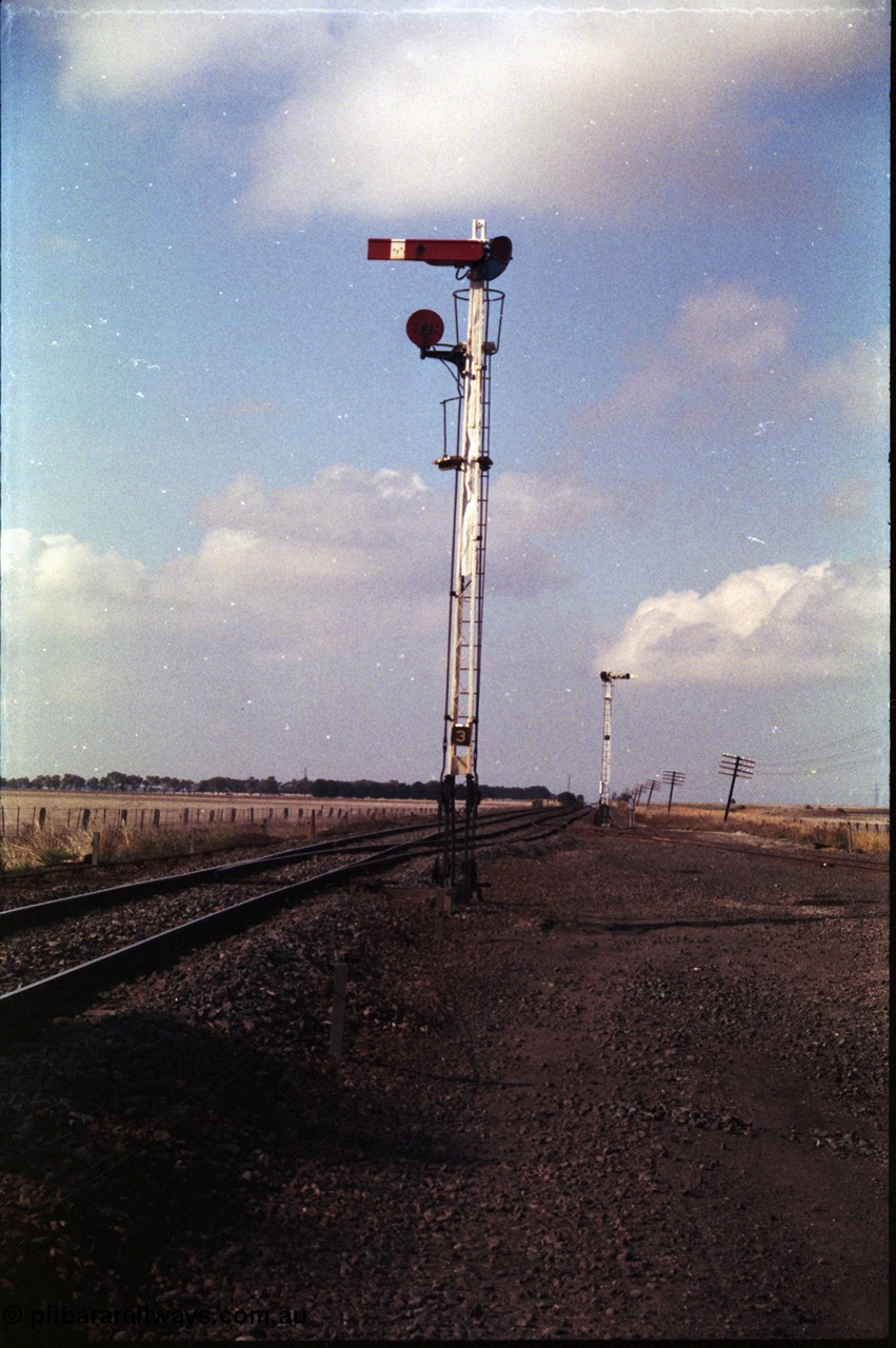 151-08
Gheringhap semaphore signal post three, up home for No.1 Road, semaphore for the mainline, disc for A Siding, semaphore signal post two visible, track to the right is B Sidings.
