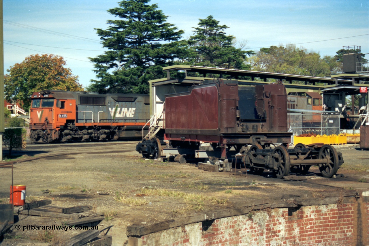 153-2-12
Ballarat East loco depot, turntable pit in bottom corner of frame, D3 class tender under going rebuild, V/Line broad gauge N class N 455 'City of Swan Hill' Clyde Engineering EMD model JT22HC-2 serial 85-1223 next to fuel and sanding sheds, obscured Y class Y 165 Clyde Engineering EMD model G6B serial 68-585.
