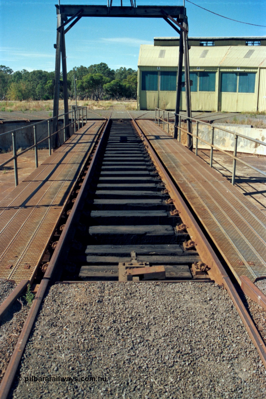 153-2-27
Ararat loco depot, turntable deck view looking from yard access track, three stall roundhouse.
