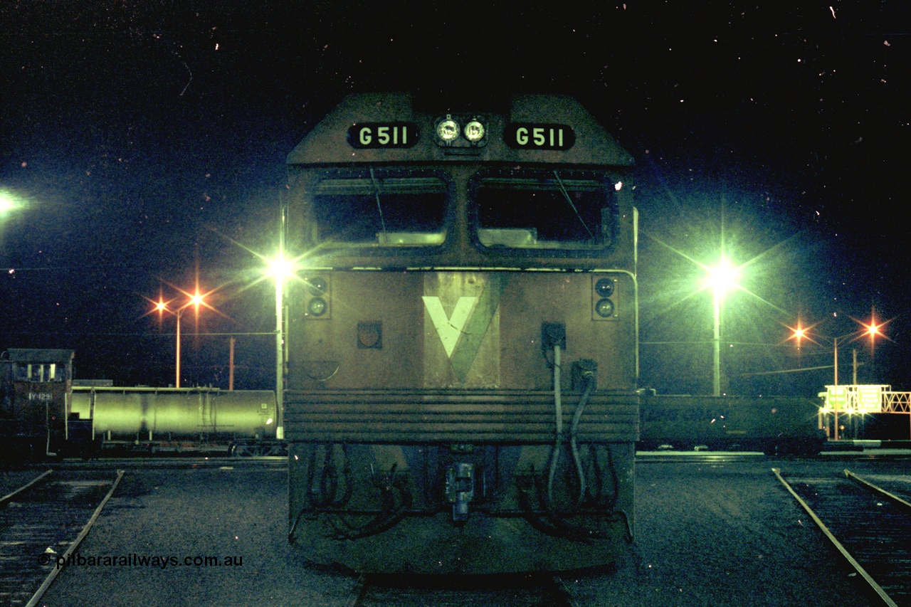 153-3-29
Geelong loco depot, stabled V/Line broad gauge locomotive and class leader G class G 511 Clyde Engineering EMD model JT26C-2SS serial 84-1239, cab front, night shot.
Keywords: G-class;G511;Clyde-Engineering-Rosewater-SA;EMD;JT26C-2SS;84-1239;
