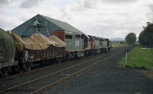 154-22
Lismore, V/Line broad gauge C class C 510 Clyde Engineering EMD model GT26C serial 76-833, C 508 serial 76-831 and C class leader C 501 'George Brown' serial 76-824, with VCCX type bogie open steel transport waggon VCCX 6, lead the Adelaide bound goods train 9169 past the grain bunker on No.3 Rd, train is on No.2 Rd as the unattended crossing loops utilise left hand lay trailable points.
Keywords: C-class;C501;Clyde-Engineering-Rosewater-SA;EMD;GT26C;76-824;