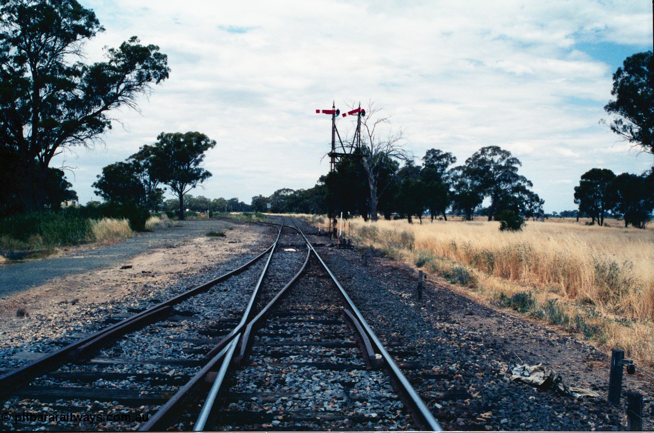 156-24
Numurkah, Picola Junction looking north from the end of Numurkah yard, line to Strathmerton is straight, Picola line branches off to the left, double doll semaphore signal post pulled off for Strathmerton line.
