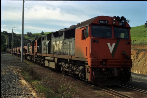 157-11
Kilmore East, Apex Quarry Siding, V/Line broad gauge locomotives N class N 471 'City of Benalla' Clyde Engineering EMD model JT22HC-2 serial 87-1200 and T class T 390 Clyde Engineering EMD model G8B serial 65-420 prepare to push back under the loading bins with the empty rake.
Keywords: N-class;N471;Clyde-Engineering-Somerton-Victoria;EMD;JT22HC-2;87-1200;