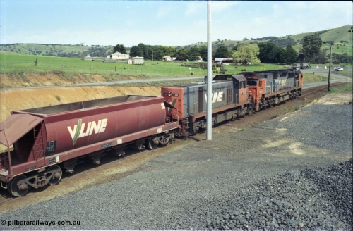 157-16
Kilmore East, Apex Quarry Siding, V/Line broad gauge locomotives N class N 471 'City of Benalla' Clyde Engineering EMD model JT22HC-2 serial 87-1200 and T class T 390 Clyde Engineering EMD model G8B serial 65-420 and VHQF type bogie quarry products waggon VHQF 414, trailing view taken from on top of ballast pile.
Keywords: T-class;T390;Clyde-Engineering-Granville-NSW;EMD;G8B;65-420;