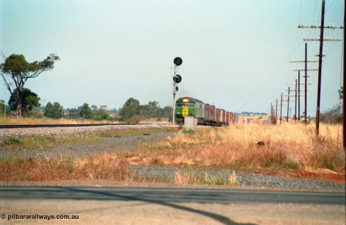 159-08
Rockbank, double Australian National broad gauge BL class locomotives lead a down Adelaide bound goods train at the down home signal post for the crossing loop.
