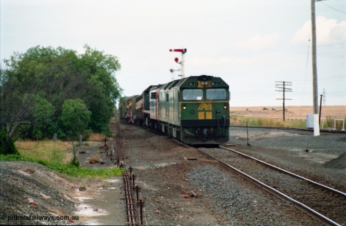 159-11
Gheringhap, track view looking east towards Geelong from the former No.2 platform, signal rodding running along edge of platform, Australian National broad gauge BL class BL 27 Clyde Engineering EMD model JT26C-2SS serial 83-1011 leads sister BL class and a V/Line S class and X class locomotives with down goods train 9169 as it arrives on their way to Adelaide.
Keywords: BL-class;BL27;Clyde-Engineering-Rosewater-SA;EMD;JT26C-2SS;83-1011;