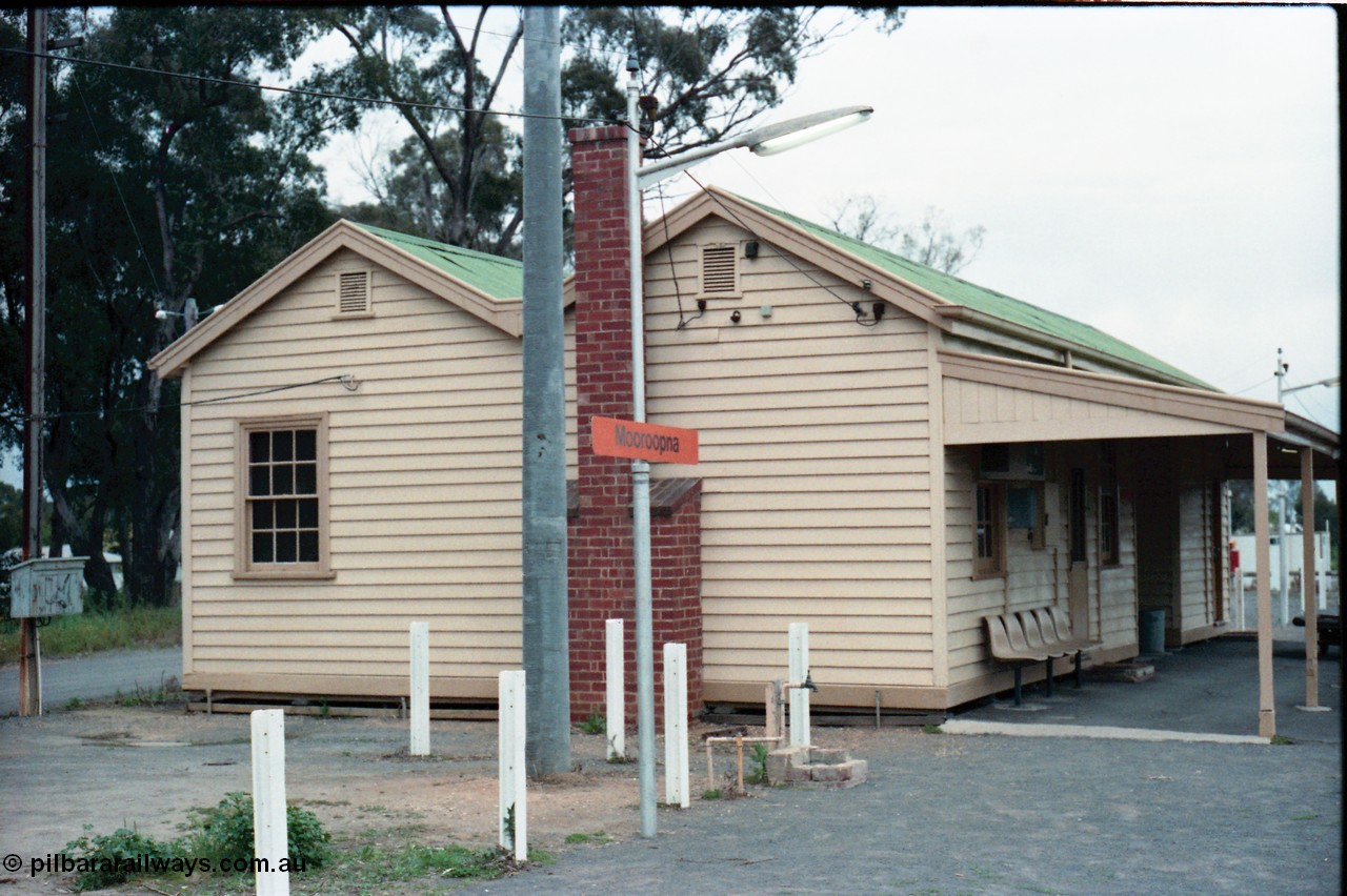 160-13
Mooroopna, platform view of the station building, shows fire place chimney and the various service connections to the building.
