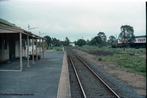 160-14
Mooroopna, view from station platform looking towards Melbourne, station building and platform trolley at left, Ardmona Canned Fruit loading sidings at right, on the left beyond the station building is the hard stand area for the mobile gang camp, with caravan type plugs and permanent ablution block.
