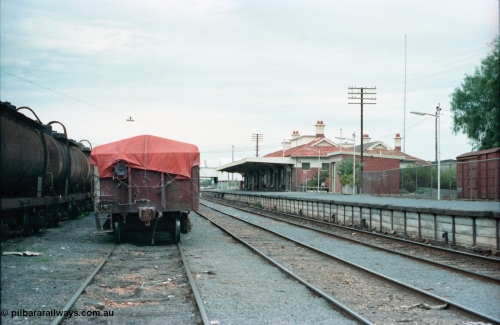 160-20
Shepparton yard view, stabled fuel train on No.4 Rd at left, hand brake end of super phosphate waggon, rear of stabled Shepparton goods train on No.3 Rd, station building and platform on the right.

