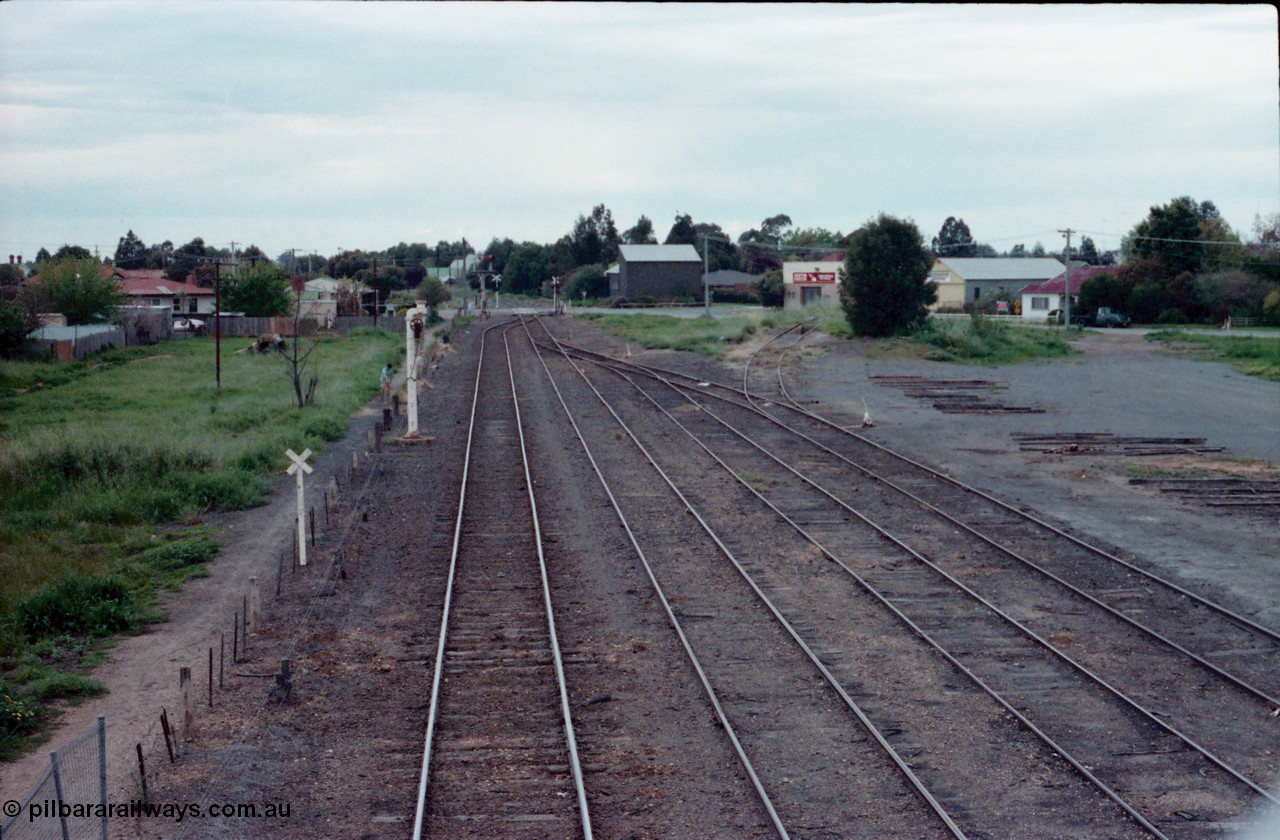 161-02
Numurkah, station yard overview looking north towards Picola Junction, steam era stand pipe remains on No.1 Rd, semaphore signal post remains with Picola Line doll removed, the down starting semaphore for the Strathmerton line is visible in the trees, track to turntable and ash pit at right.
