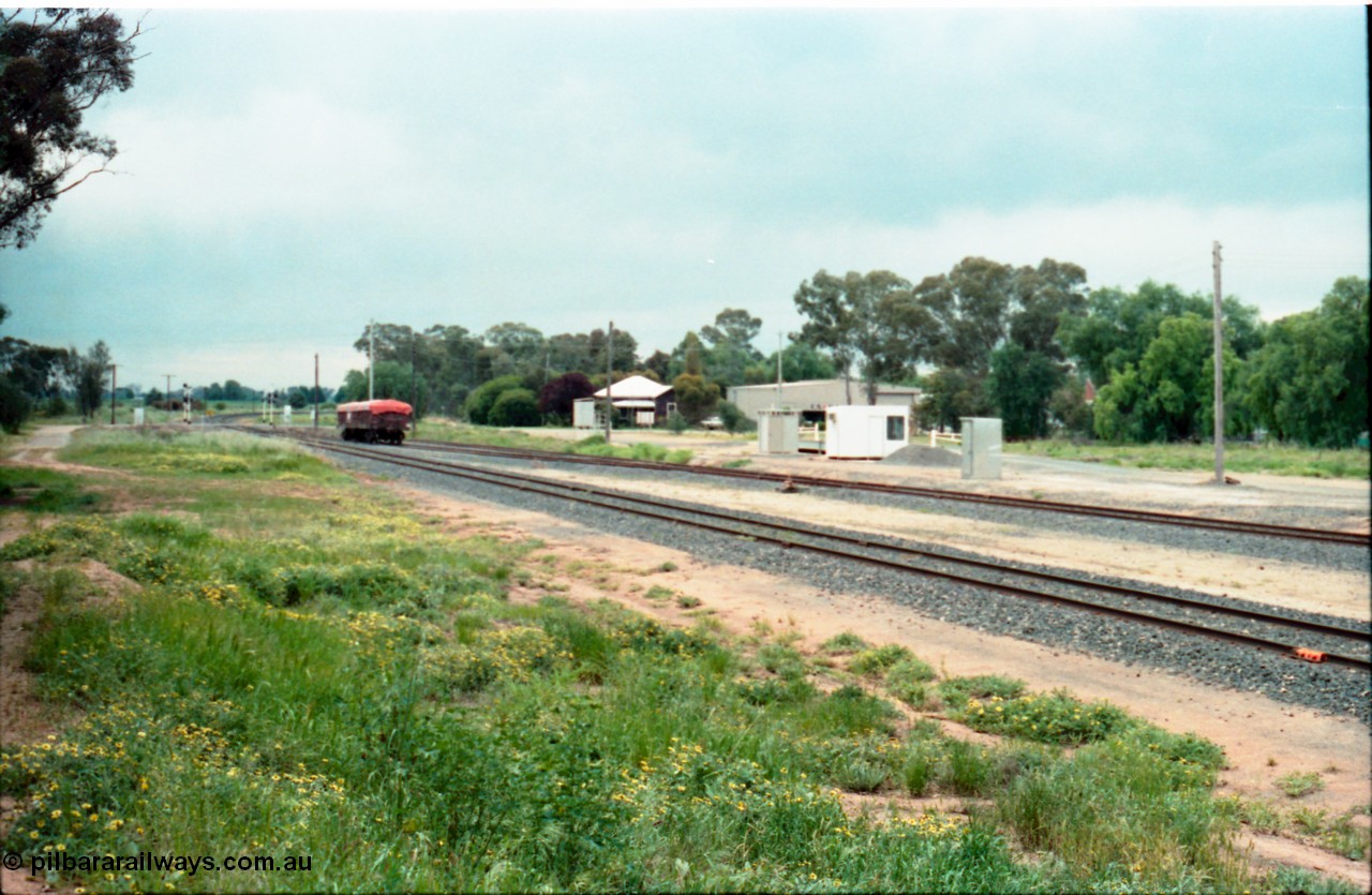 161-12
Katunga, yard overview looking north from former station site, grade crossing for Picola Road, derailed V/Line VOFX type bogie open waggon covered with tarpaulin, road vehicle weighbridge and train control phone cabin middle right of frame.
Keywords: VOFX-type;VOFX1044;Victorian-Railways-Bendigo-WS;ELX-type;