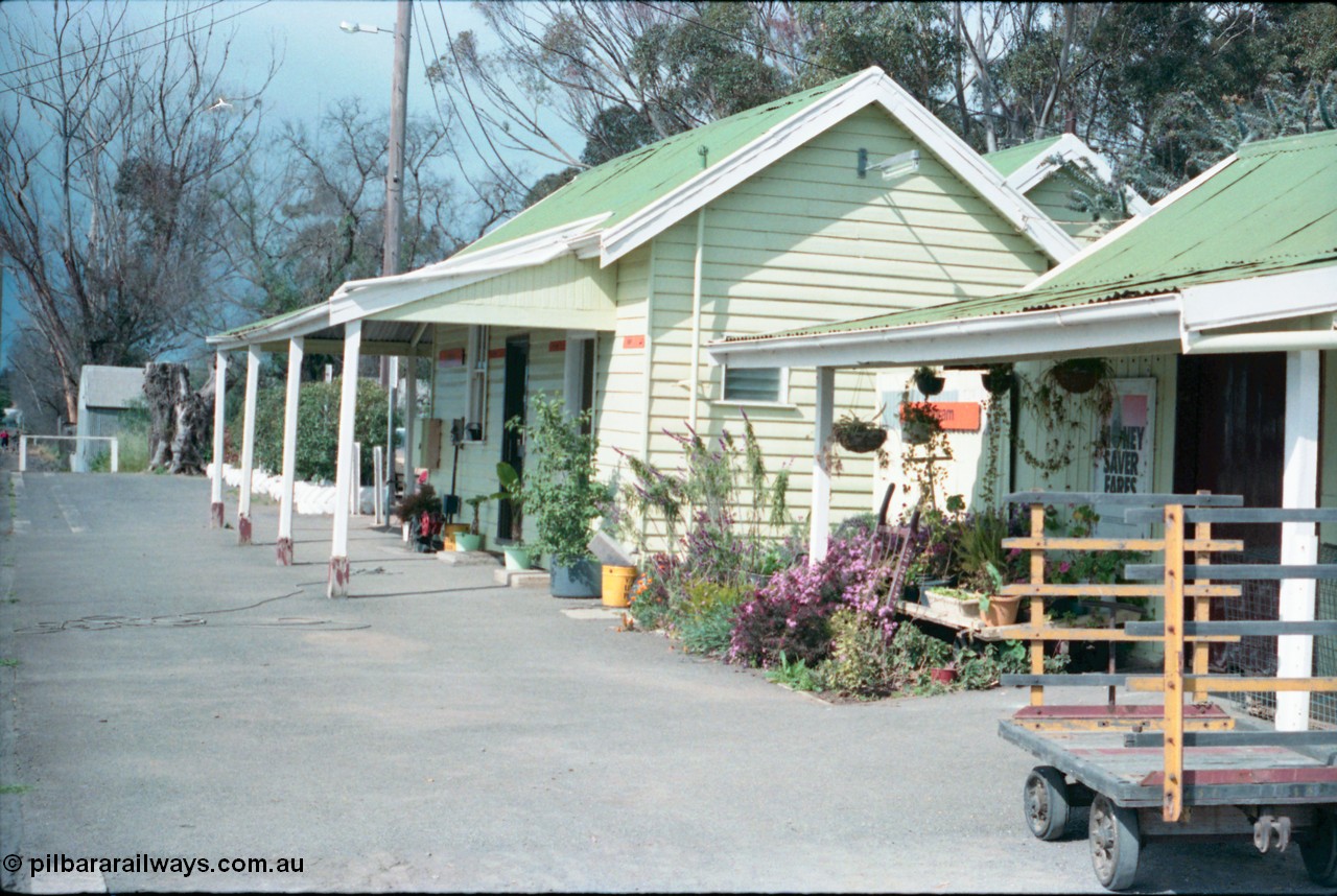 161-20
Cobram, station platform and building overview, show well maintained garden, luggage trolley, the way we were.
