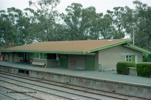 161-00
Numurkah, station building overview of modern brick structure, signal bay opening and weigh scales are reminders of an older era, taken from footbridge.
