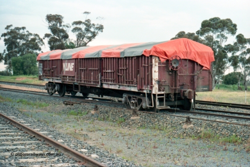 161-13
Katunga, north end of yard view with derailed V/Line broad gauge VOFX type bogie open waggon VOFX 1044 covered with tarpaulin and loaded with super phosphate, hand brake end, waggon started life built by Victorian Railways Bendigo Workshops in May 1975 as an ELX type, in 1978 to VOCX and in the 1980s to VOFX, point rodding for derail and derail visible under middle of waggon, mainline behind waggon.
Keywords: VOFX-type;VOFX1044;Victorian-Railways-Bendigo-WS;ELX-type;