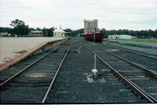 161-30
Tocumwal, broad gauge station yard overview looking south from end of platform, track and points and levers, station building and sleeper transport waggons, a hotel and flour mill in the background.
