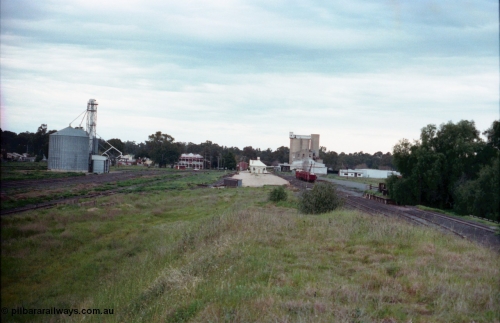 161-34
Tocumwal, station yard overview looking south, the yard on the left is the broad and standard gauge trans-shipping yards, the silos are serviced by broad gauge rails, the station building, platform and fetters trolley shed are in the middle, hotel and derelict flour mill form the backdrop and the broad gauge yard with V/Line sleeper transport waggons and broad gauge cattle yards on the right side. The track ending at the yards is the standard gauge cattle yards track.
