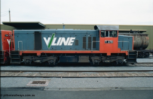 163-23
Shepparton station view from platform with stabled V/Line broad gauge T class locomotive T 379 Clyde Engineering EMD model G8B serial 64-334, goods shed behind loco, side view.
Keywords: T-class;T379;Clyde-Engineering-Granville-NSW;EMD;G8B;64-334;