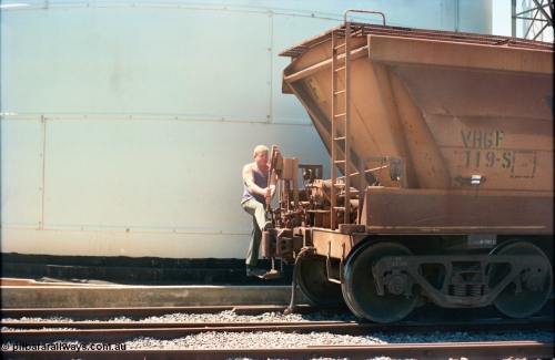 164-15
Murchison East, broad gauge V/Line Grain VHGF type bogie grain waggon VHGF 119, built as a GJX type by Steelweld Victoria in January 1969, showing signs of being recoded from VHGY has a GEB worker operating the lever action handbrake as the rake is moved down the road under its' own weight.
Keywords: VHGF-type;VHGF119;Steelweld-Vic;GJX-type;