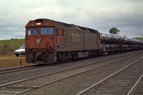 166-18
Wandong, down V/Line standard gauge car or Ford train behind G class G 526 Clyde Engineering EMD model JT26C-2SS serial 88-1256 with a rake of loaded motor car transport waggons conveying Ford motor cars from their Somerton plant to NSW, at Mathiesons Siding - O'Gradys Road grade crossing.
Keywords: G-class;G526;Clyde-Engineering-Somerton-Victoria;EMD;JT26C-2SS;88-1256;