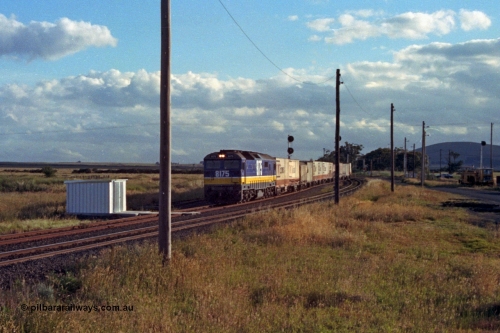 167-02
Wallan Loop south end of standard gauge loop, standard gauge gangers trolley shed, NSWSRA 81 class loco 8175 Clyde Engineering EMD model JT26C-2SS serial 85-1094 in new Freight Rail 'Stealth' livery takes the loop road with a north bound goods service, broad gauge tracks and tamper at right.
Keywords: 81-class;8175;Clyde-Engineering-Kelso-NSW;EMD;JT26C-2SS;85-1094;