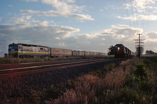 167-08
Wallan Loop, north end, standard gauge NSWSRA 81 class loco 8175 Clyde Engineering EMD model JT26C-2SS serial 85-1094 in the new Freight Rail 'Stealth' livery holds the loop while broad gauge V/Line X and N classes blast north with a down passenger train on the broad gauge tracks.
Keywords: 81-class;8175;Clyde-Engineering-Kelso-NSW;EMD;JT26C-2SS;85-1094;