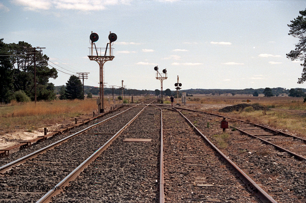 171-07
Trawalla station yard overview, looking towards Ararat, searchlight Signal Post 5 facing camera with left light Home No. 1 Road to Main Line and the right Home No. 2 Road to Main Line, Signal Post 6 facing away, point rodding, No.3 Road catch point and indicator, Waterloo Road grade crossing.
